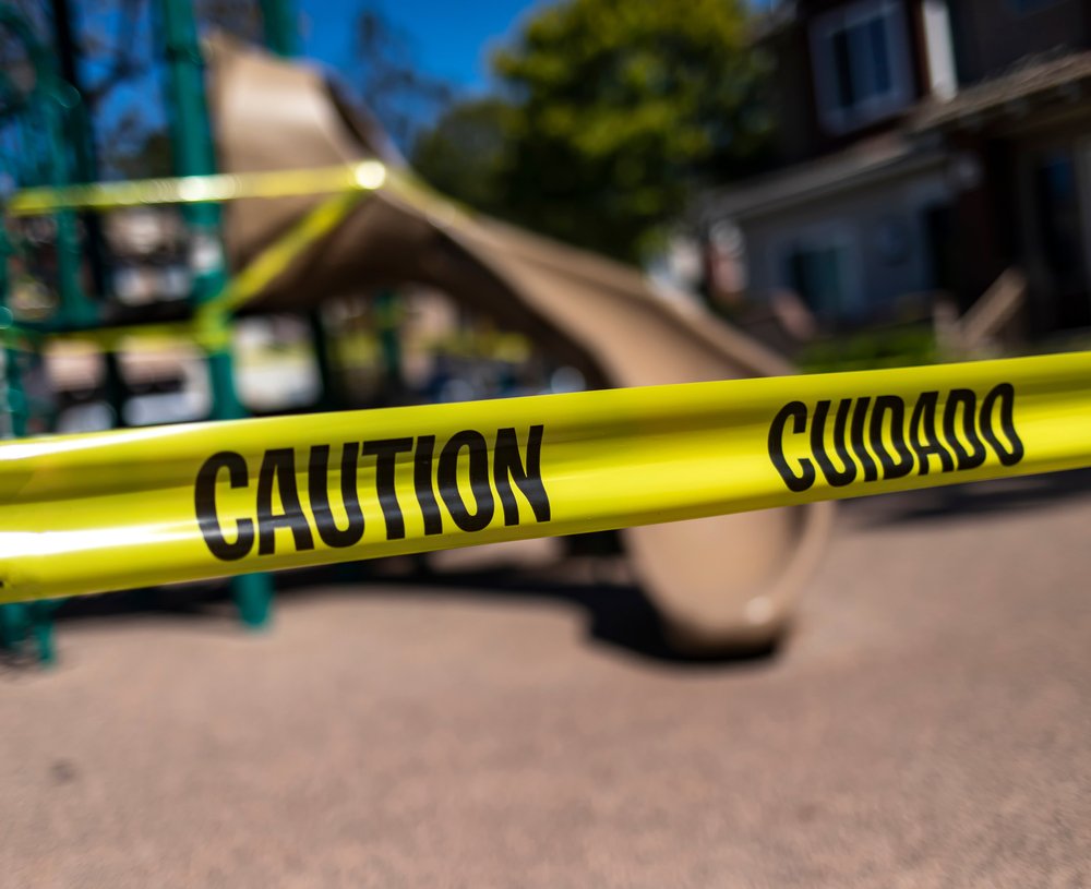 Texas premises liability attorney examining unsafe property conditions marked by caution tape.