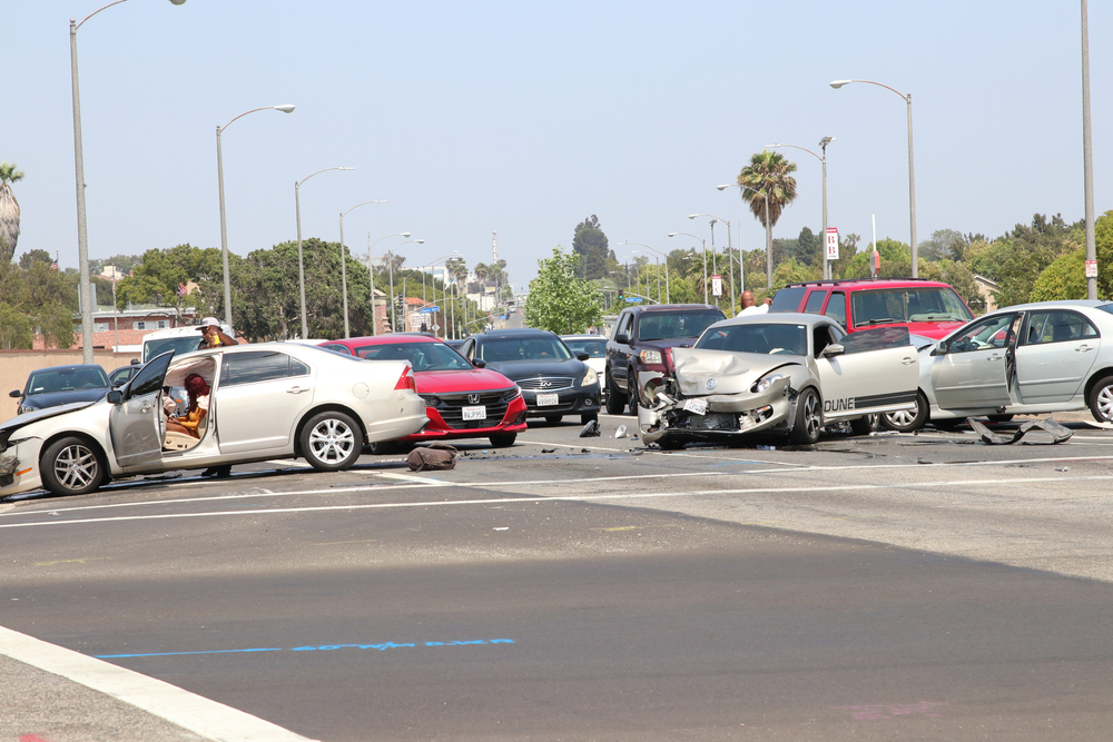 Dallas car accident lawyer investigating a multi-car accident at a busy intersection.