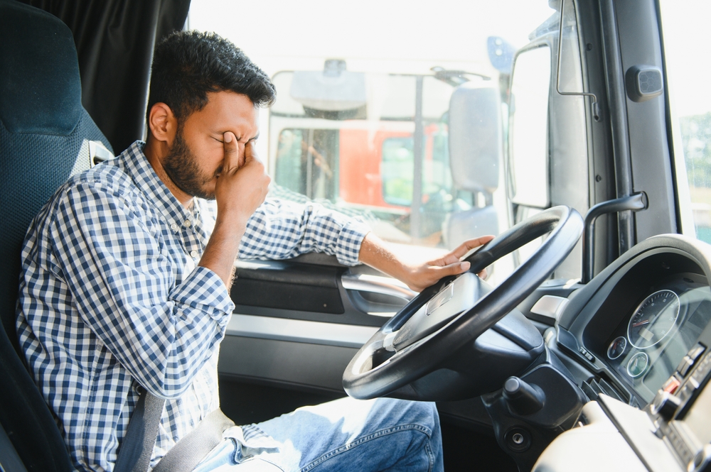 Fatigued truck driver behind the wheel, a common cause of crashes handled by a Dallas truck accident lawyer.
