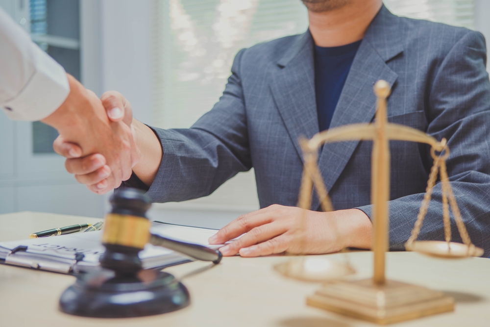 Richardson personal injury lawyer shaking hands with client during consultation